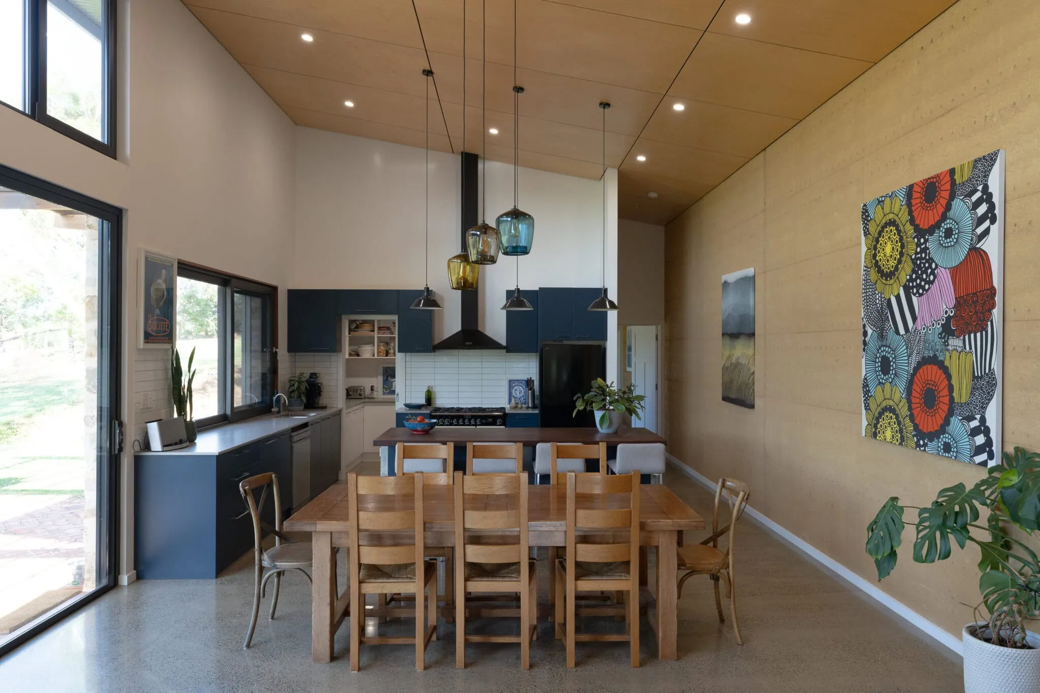 Bright and spacious open-plan kitchen with contemporary decor and ample natural light.