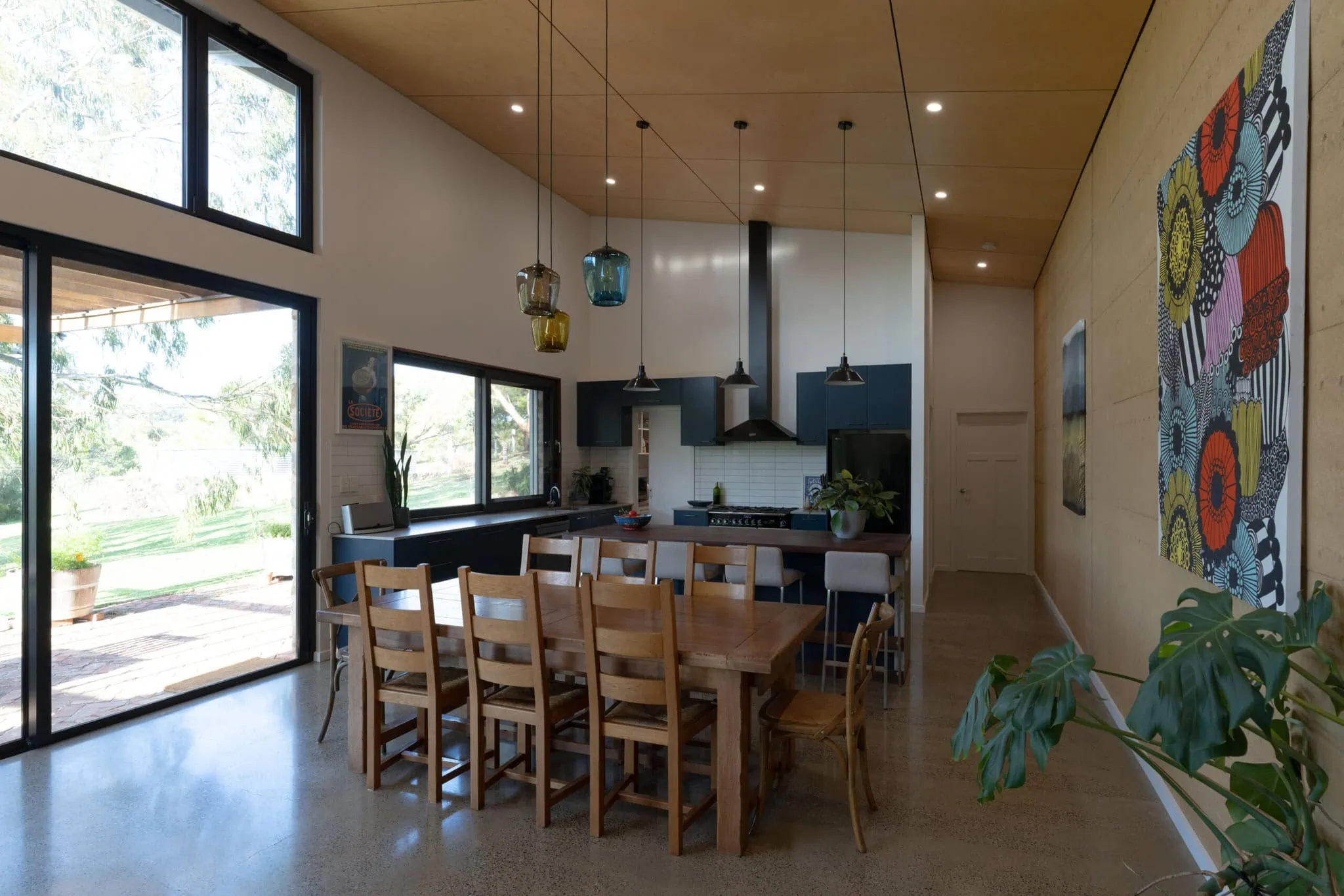 Bright, spacious kitchen with natural light, stylish cabinetry, and contemporary decor in a family home.