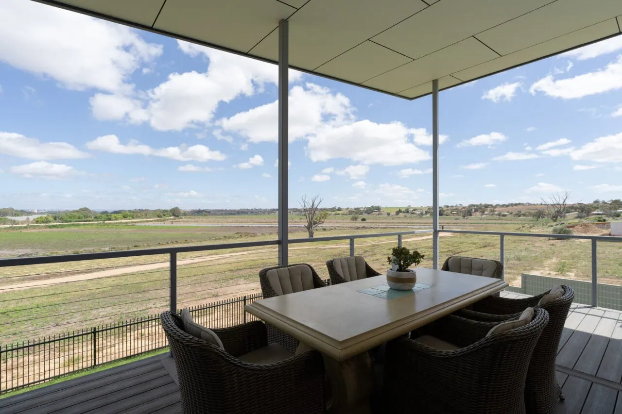 Outdoor entertainment area overlooking farmland and open fields.