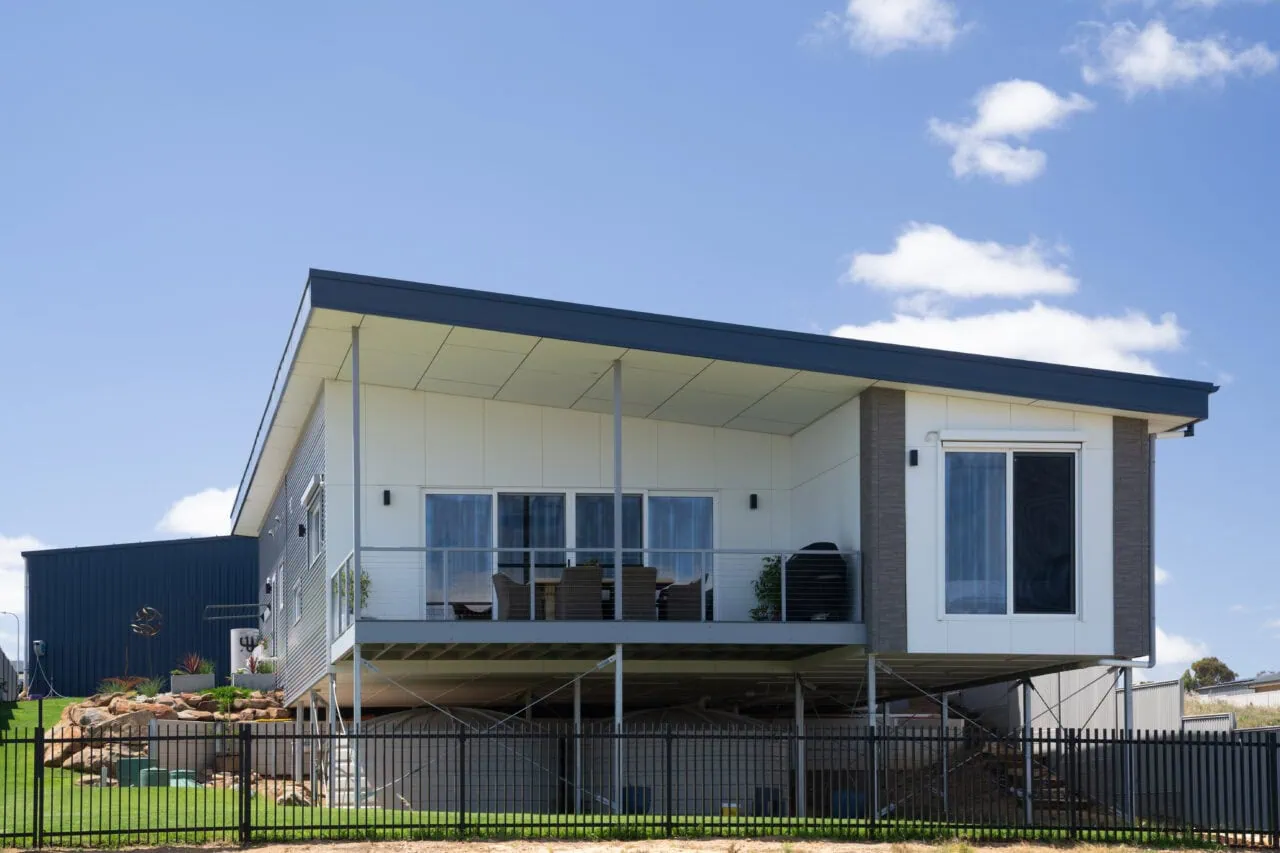 Beautifully designed elevated house with outdoor deck, perfect for outdoor living and entertaining.