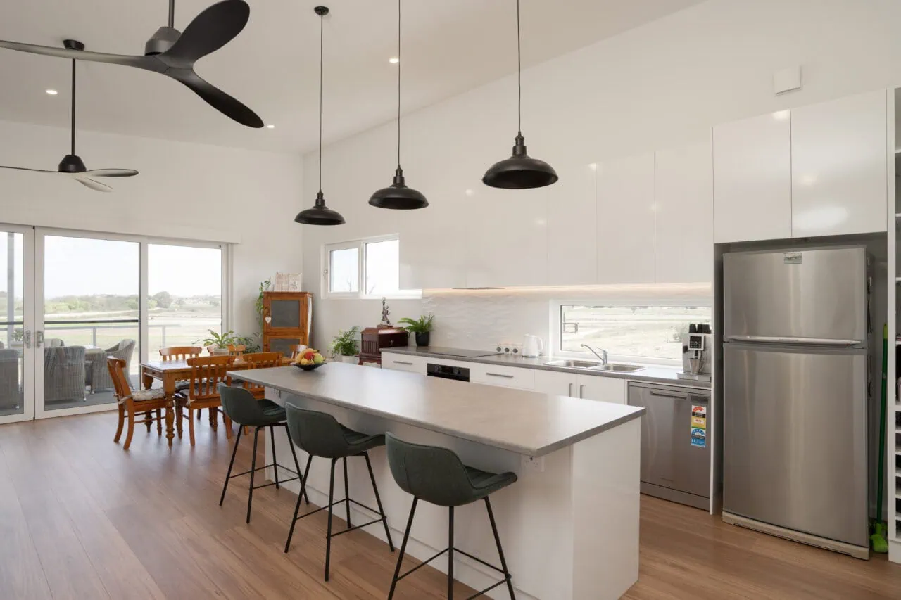 Bright contemporary kitchen with white cabinets, large island, and ample natural light suitable for Australian homes.
