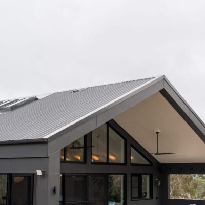 Contemporary black roof home with large windows and modern design in Australia.