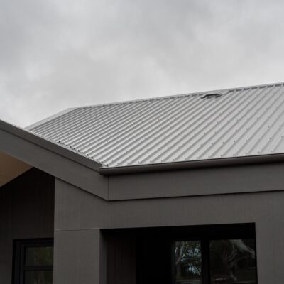 Black metal roof and exterior cladding for modern home construction.