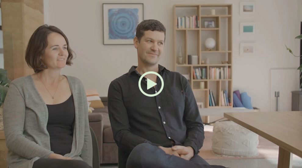 Expert home renovation consultation with a couple discussing project ideas in a contemporary living.
