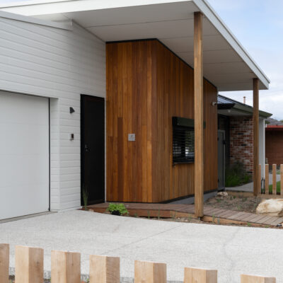 Contemporary house with wooden accents and a covered entrance.