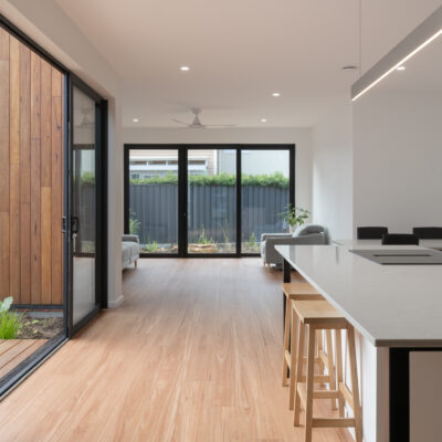 Contemporary open-plan living and kitchen area at Project West Beach.