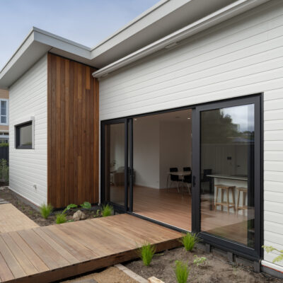 Contemporary house with white cladding and wooden accents at Project West Beach.