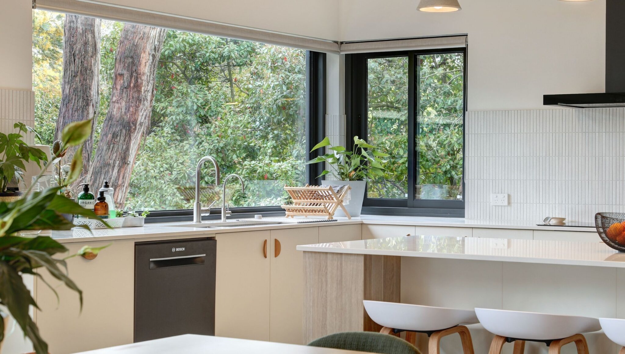 Contemporary kitchen with large windows and natural light.