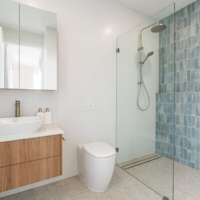 Contemporary bathroom with walk-in shower, vanity, and minimalist decor.
