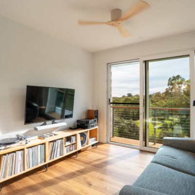 Bright living room with large balcony doors and scenic outdoor view.