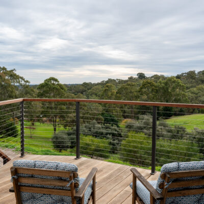 Balcony with two chairs overlooking lush green landscape in Aberfoyle Park.