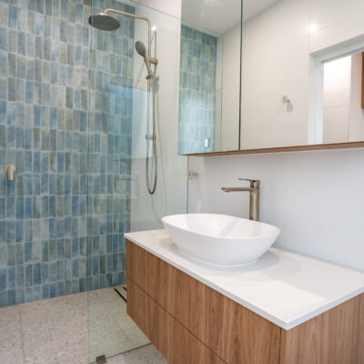 Contemporary bathroom with walk-in shower and wooden vanity.