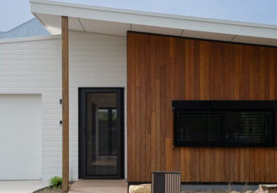 Contemporary house with wooden and white exterior, modern design, and large window.